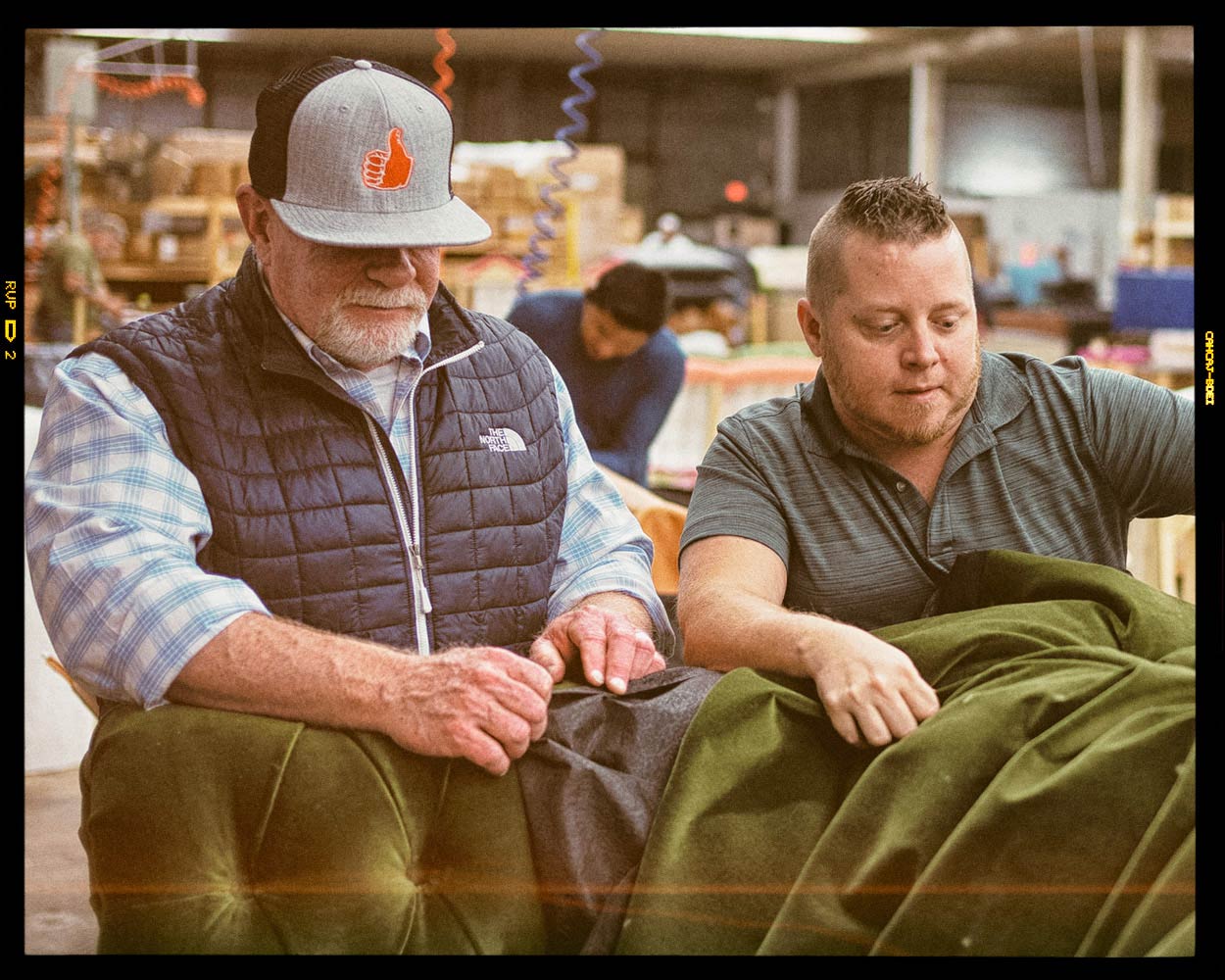 Roger and Alan examine a tufted sofa