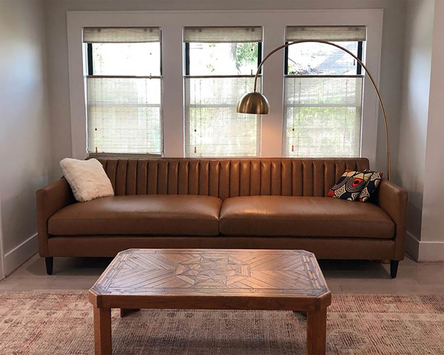 Channel tufted sofa in brown leather