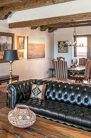 Higgins Chesterfield sofa in Perspective Pitch Dark black leather with tufted seat. Photo courtesy Erica Ortiz Berke, NeuBleu Interior Design.