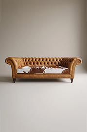 92 Lucille sofa in Run Wyld Gentle Fawn brown performance leather with Holstein brown and white hair-on-hide cushion