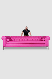 118 Eliza Modern Chesterfield sofa in Brisa Fresco Hibiscus pink faux leather with crystal button accents and metal legs, with Chris to show scale