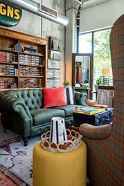 Cecil sofa in Vintage Envy green leather with contrasting orange buttons and orange stitching