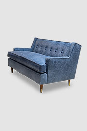 Ladybird sofa in Caprieze Denim Style blue leather with bench cushion and taper legs with sabots