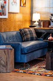 Ladybird sofa in Caprieze Denim Style blue leather with bench cushion and taper legs with sabots