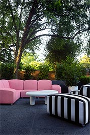 Amalfi outdoor sectional in Barbados Pink performance fabric and armchair in Sunbrella Cabana Classic performance fabric