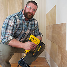 Chris applies paneling to the lower walls.