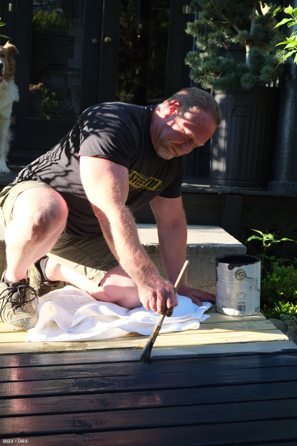 Roger paints the boardwalk.