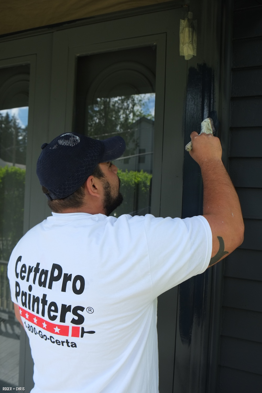 Joey paints the front door.