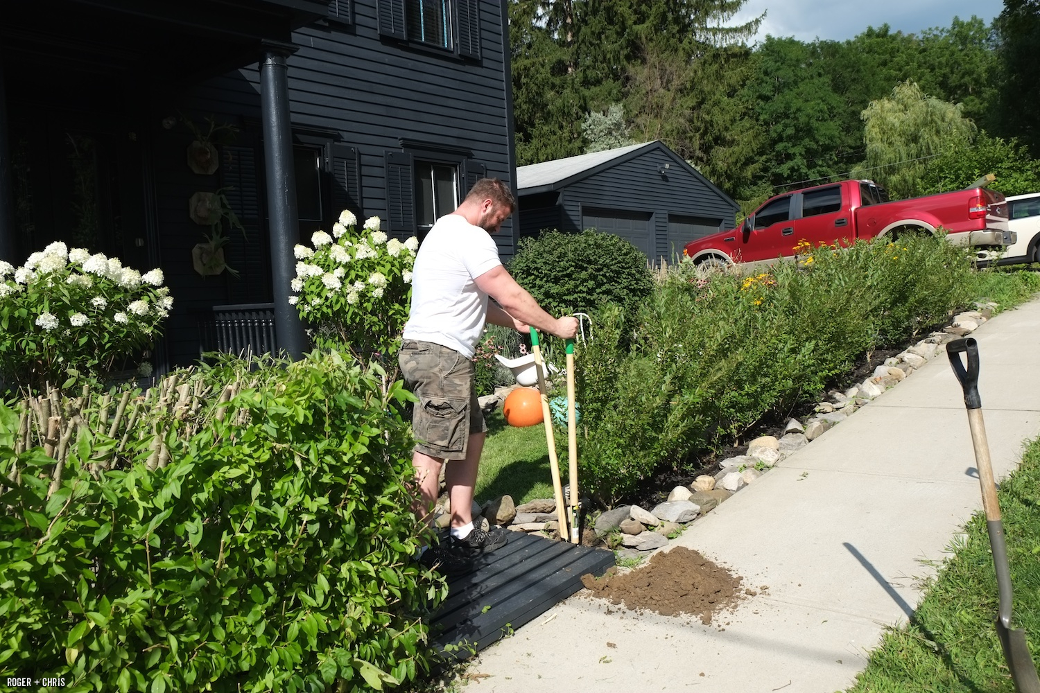 Chris digs holes for gate posts.